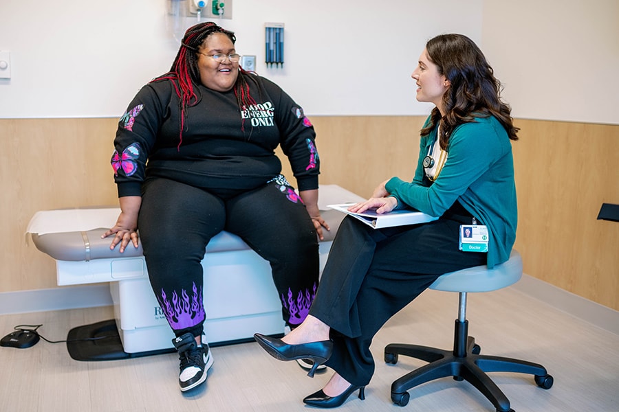 Strong4Lice Clinic Medical Director Jessica Reilly, MD, consulting with a bariatric patient