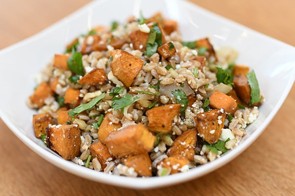 Plated farro salad recipe with oven-roasted sweet potatoes