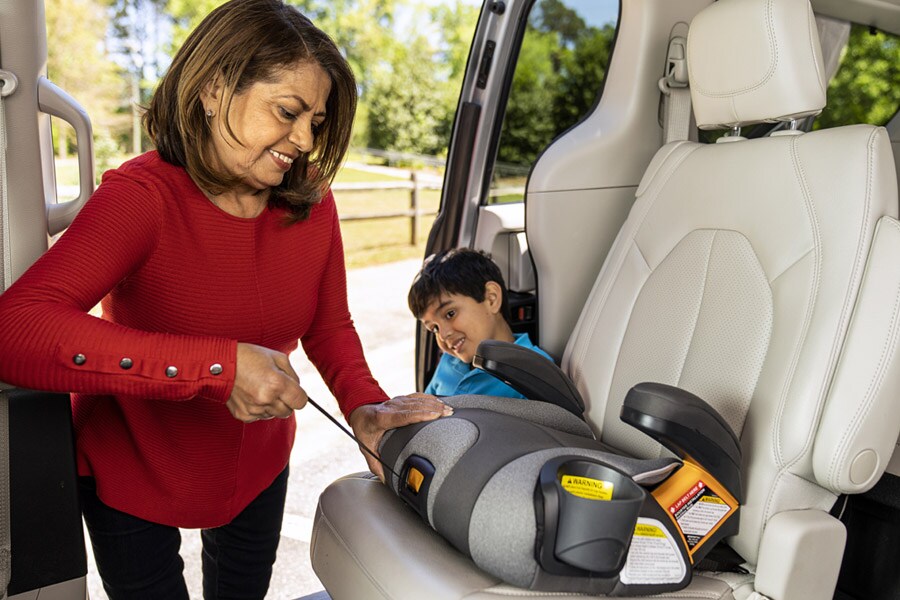 https://www.strong4life.com/-/media/Strong4Life/staying-safe/car-safety/how-to-keep-kids-safe-in-the-car/grandma_installing_low_back_booster_seat.jpg?h=600&la=en&w=900&hash=2F05C7A3C595367C5B0E79679B5E1F62F6F4676A